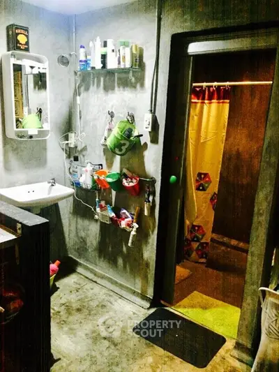 Industrial-style bathroom with concrete walls and modern fixtures.