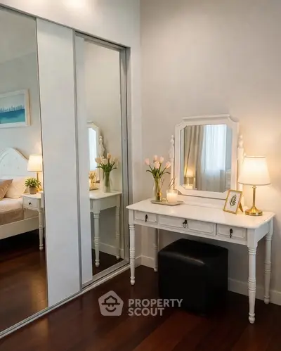 Elegant bedroom with mirrored closet and stylish vanity table