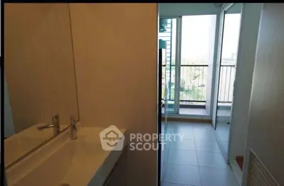 Modern bathroom with sleek sink and balcony view in a contemporary apartment.