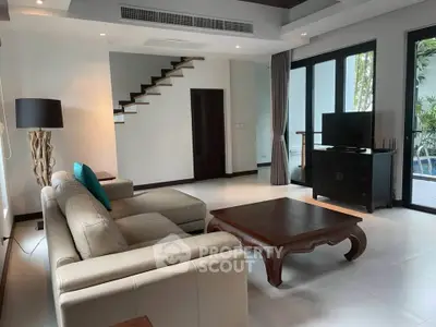 Spacious modern living room with elegant furniture and pool view