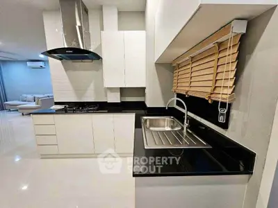 Modern kitchen with sleek black countertops and gas stove in open layout design