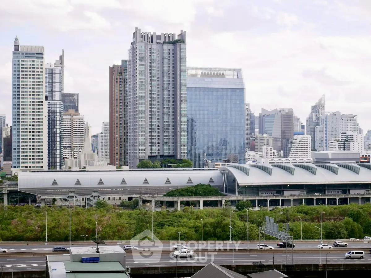Stunning cityscape view with modern high-rise buildings and lush greenery, ideal for urban living.