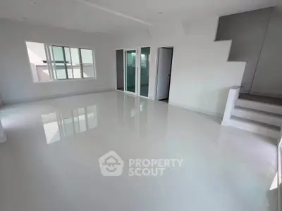 Spacious modern living room with glossy tile flooring and large windows