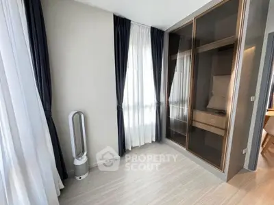 Modern bedroom with sleek wardrobe and elegant curtains, featuring a stylish air purifier for a fresh ambiance.