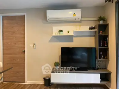 Modern living room with sleek TV unit and air conditioning, perfect for comfortable living.