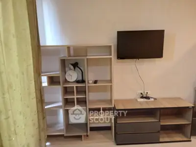 Modern living room with stylish shelving and wall-mounted TV, perfect for contemporary living.