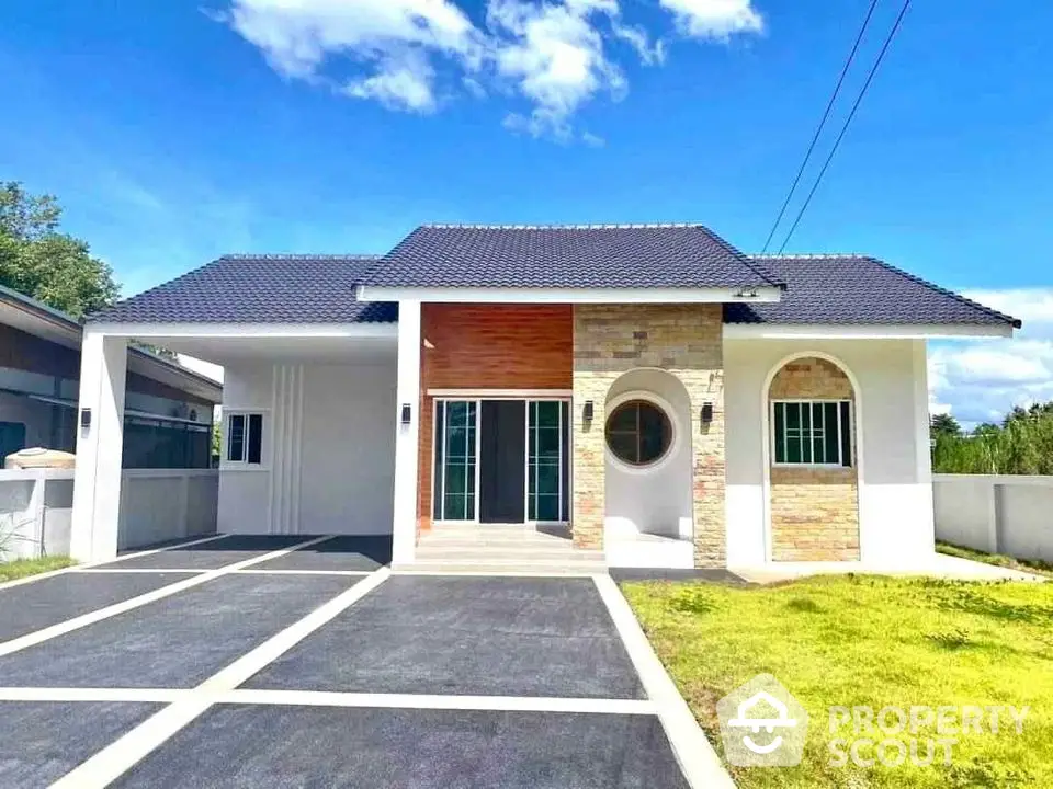 Charming single-story house with modern facade and spacious driveway