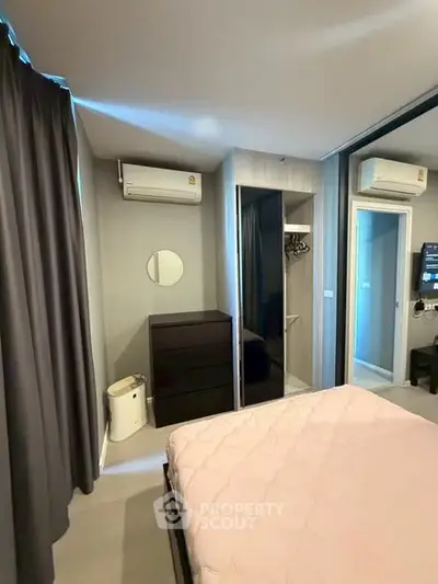 Modern bedroom with air conditioning and stylish decor in a contemporary apartment.
