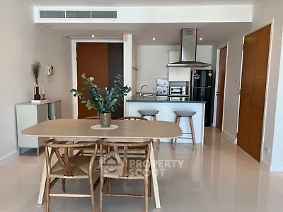 Modern kitchen with dining area featuring sleek appliances and stylish decor.