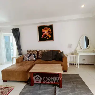 Chic living room with modern sofa, stylish decor, and natural light.