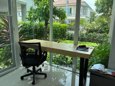 Bright study room with garden view and modern desk in a serene home setting.