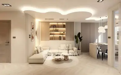 Modern living room with elegant lighting and stylish decor, featuring a cozy seating area and open dining space.