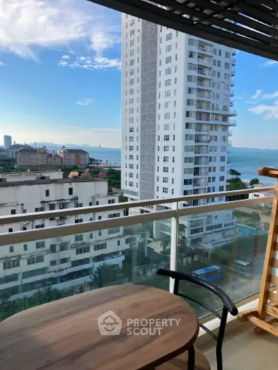 Stunning balcony view with modern high-rise and ocean backdrop