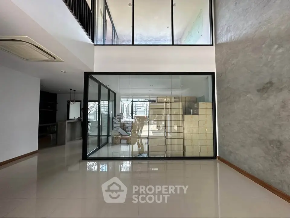 Spacious modern interior with glass walls and high ceilings, perfect for contemporary living.