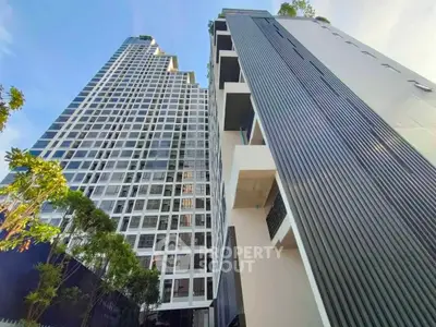 Stunning modern high-rise buildings with sleek architecture and lush greenery, perfect for urban living.