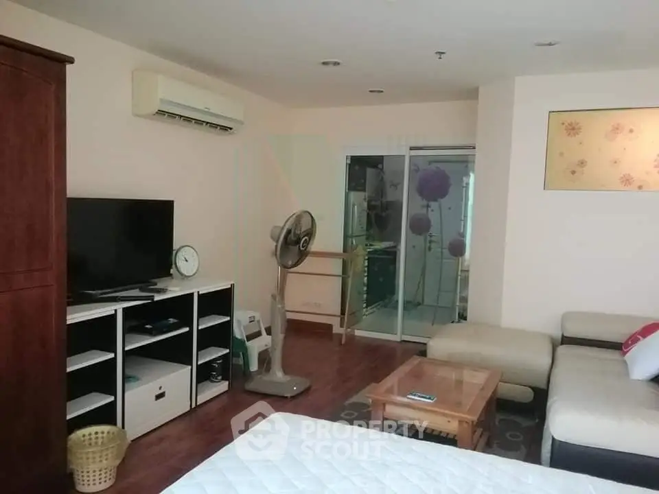 Spacious living room with modern furniture and air conditioning in a cozy apartment.
