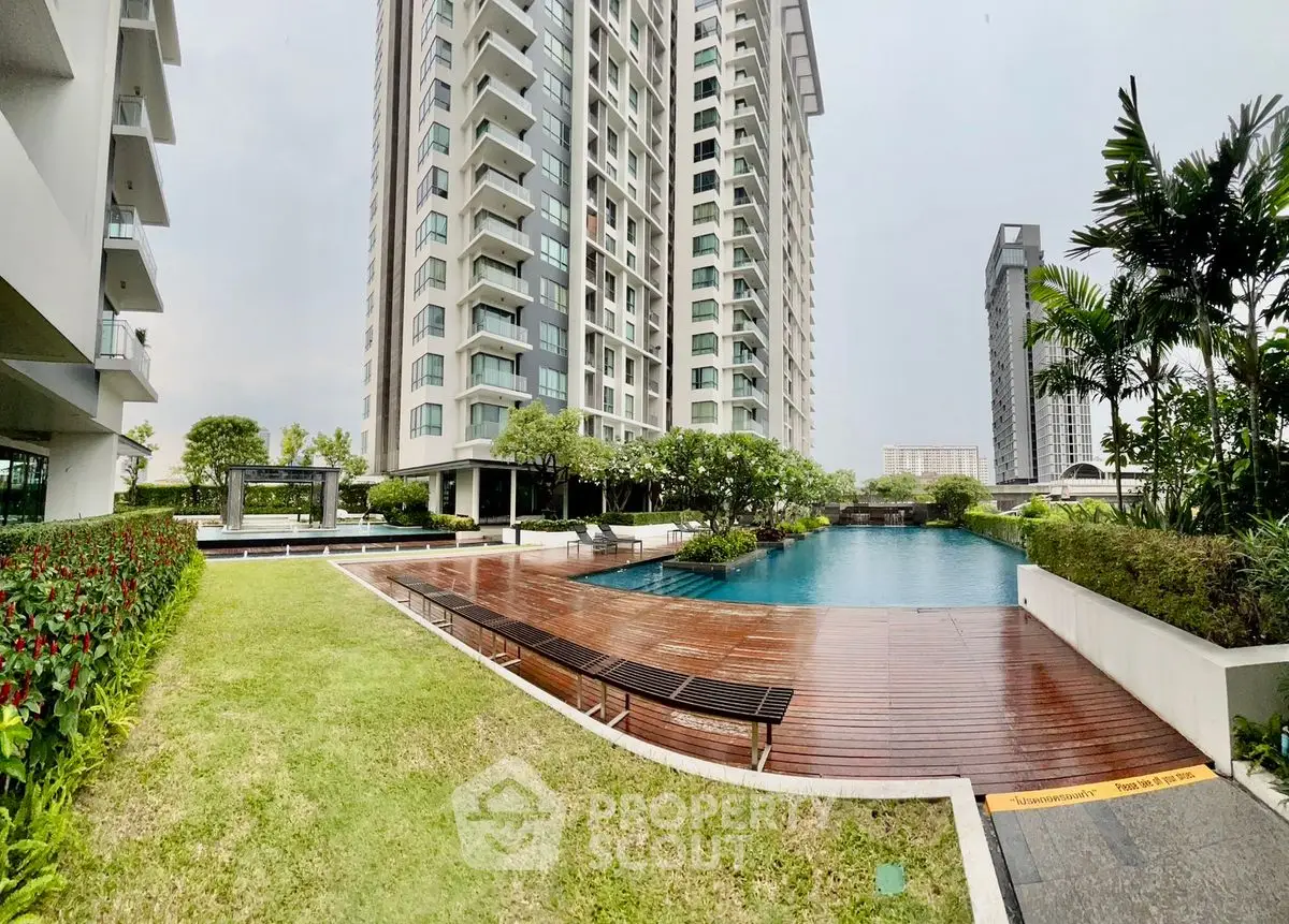 Luxurious high-rise apartment with stunning pool and landscaped garden view.