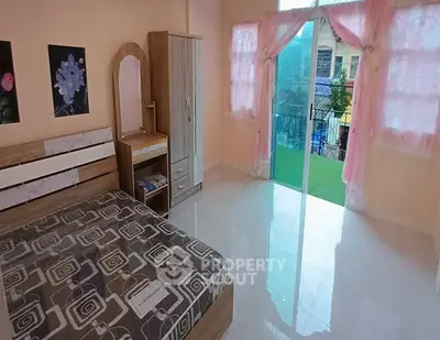 Spacious bedroom with balcony access and modern furniture