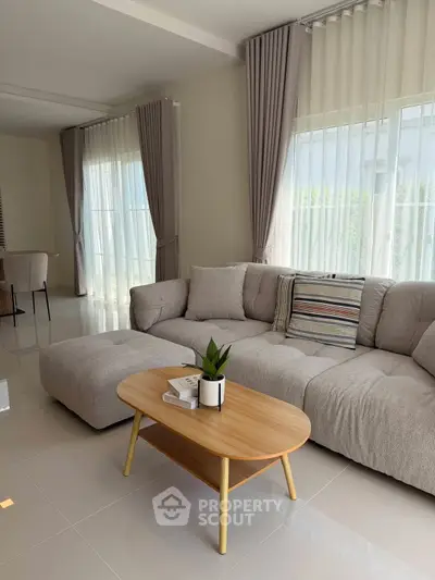 Spacious living room with modern sofa and natural light