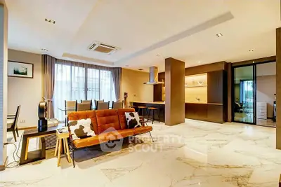 Spacious modern living room with elegant marble flooring and stylish furniture.