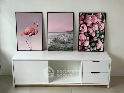 Stylish modern living room with elegant white console and artistic wall decor.