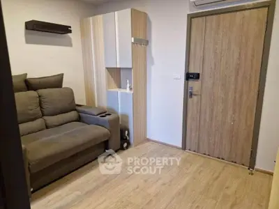 Cozy living room with modern sofa and wooden flooring in a stylish apartment.