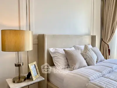 Luxurious bedroom with plush bed, elegant lamp, and stylish decor for a serene retreat.