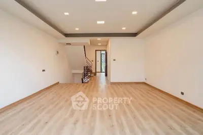 Spacious modern living room with wooden flooring and recessed lighting