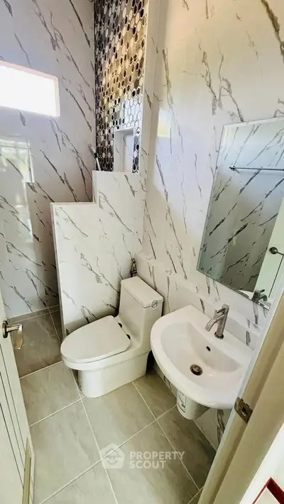 Modern bathroom with marble tiles and sleek fixtures