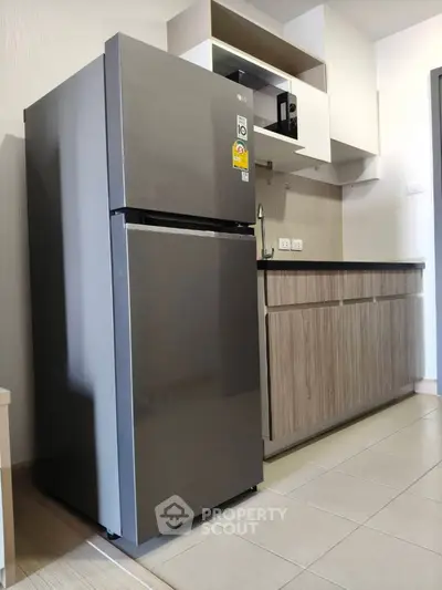 Modern kitchen with sleek stainless steel fridge and stylish cabinetry