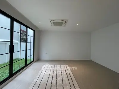 Spacious modern living room with large windows and minimalist design