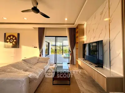 Luxurious living room with modern decor and large sliding doors to patio