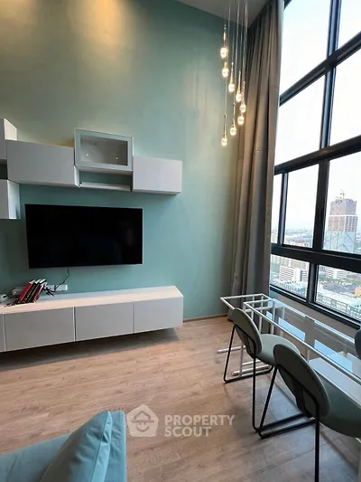 Modern living room with large windows and stylish lighting in high-rise apartment.