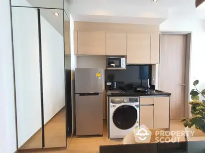 Modern compact kitchen with integrated appliances and sleek cabinetry