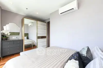 Modern bedroom with air conditioning and stylish decor in a contemporary apartment.