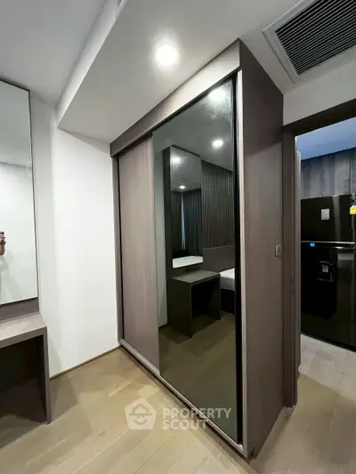 Modern bedroom with mirrored wardrobe and sleek design