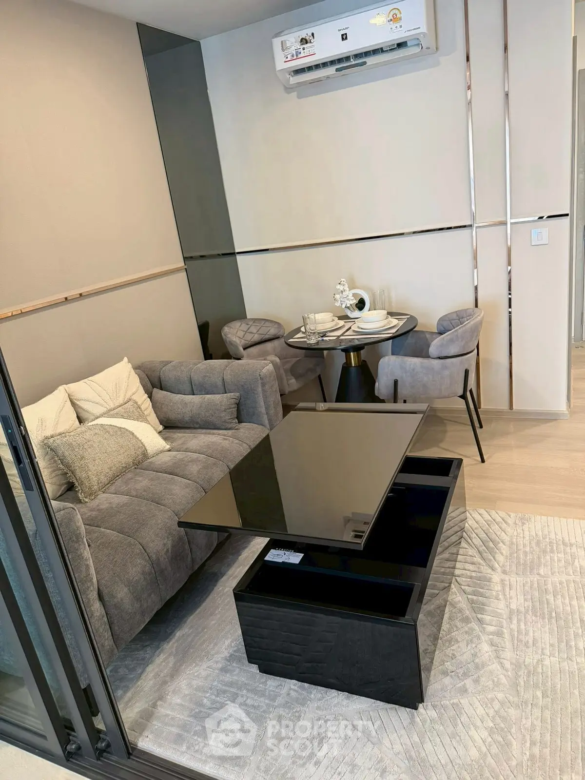 Modern living room with sleek furniture and elegant decor, featuring a cozy sofa and stylish dining area.