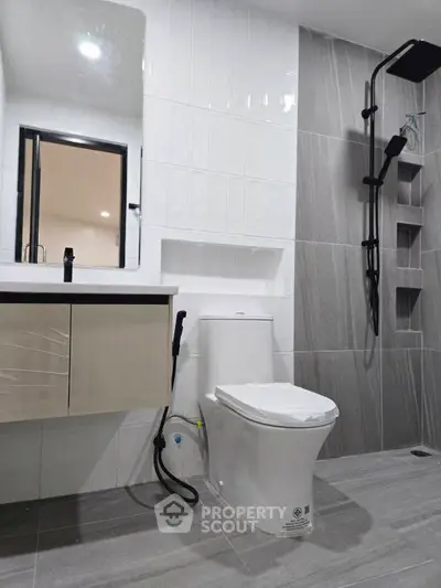 Modern bathroom with sleek fixtures and stylish gray tiles