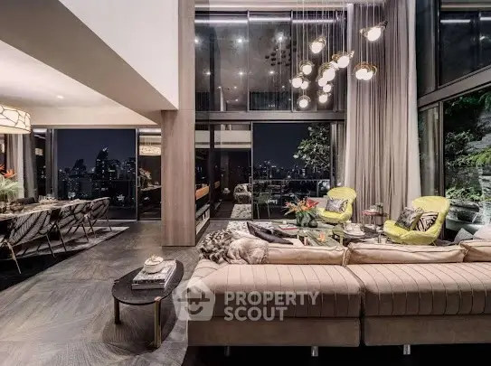 Luxurious modern living room with high ceilings and stunning city view at night.