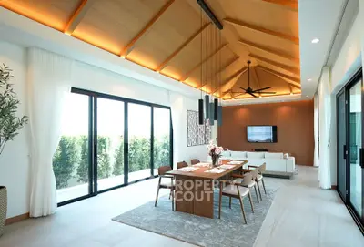 Luxurious open-plan living and dining area with high ceilings and modern decor