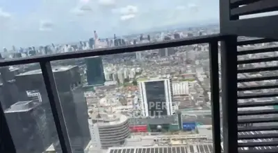 Stunning cityscape view from high-rise balcony with modern railing design.