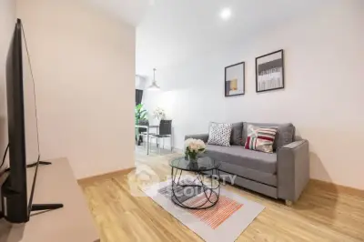 Modern living room with stylish decor and cozy seating area in a bright apartment.