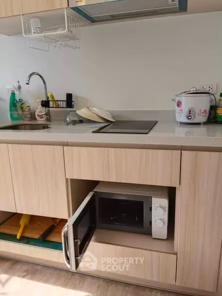 Modern kitchen with sleek cabinetry and built-in microwave