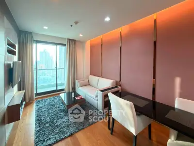 Modern living room with city view, featuring stylish furniture and warm lighting.