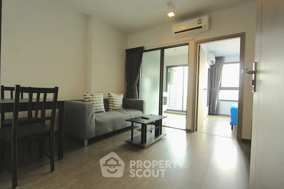Modern living room with sleek furniture and natural light in a stylish apartment.