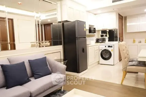 Modern open-plan kitchen with sleek appliances and cozy living area