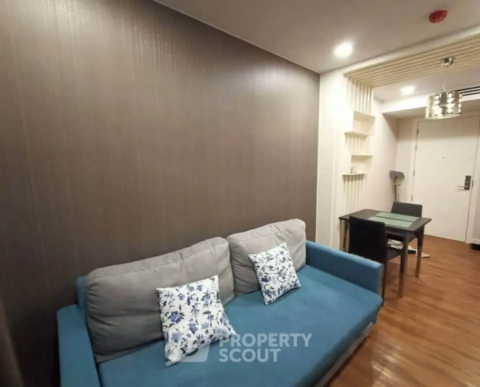 Modern living room with stylish sofa and dining area in a cozy apartment.