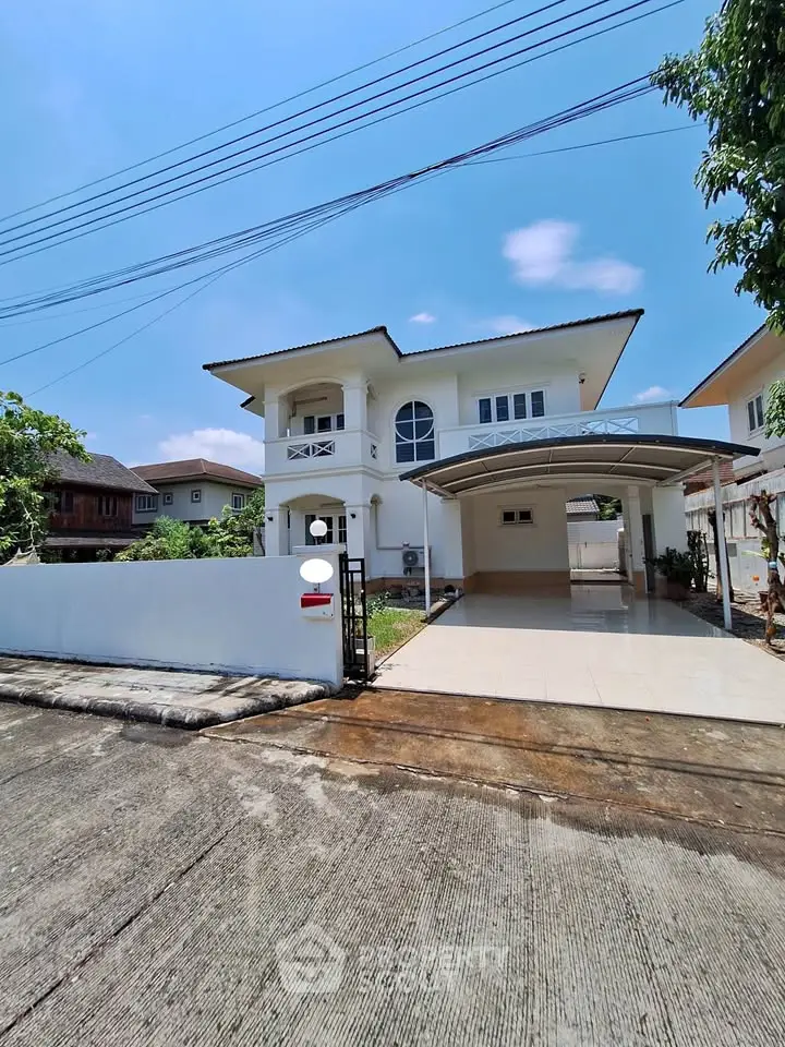 Stunning two-story white house with spacious driveway and modern design in a serene neighborhood.