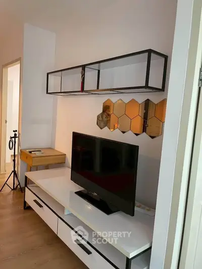 Modern living room with stylish TV stand and hexagonal wall decor