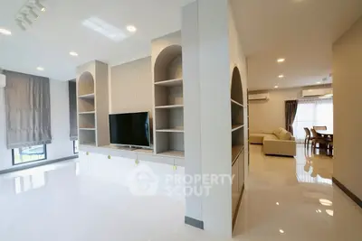Spacious modern living room with built-in TV unit and elegant dining area